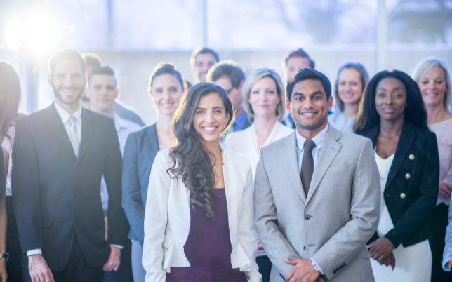 A large group of employers is standing together taking a photo.